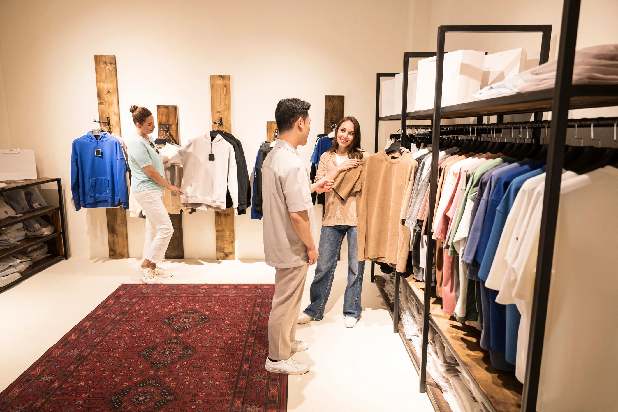 Customers browsing clothing in a modern apparel store